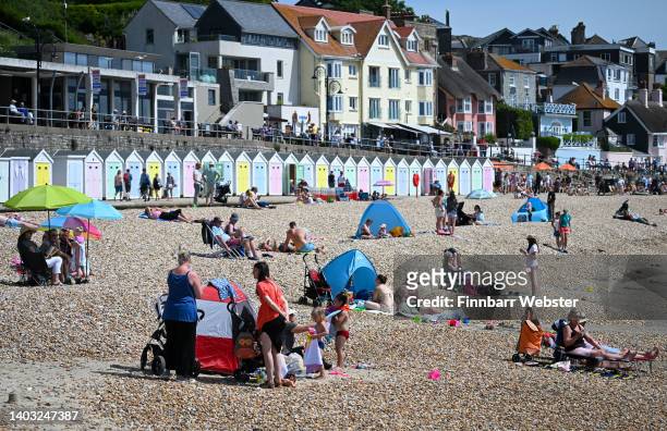 People enjoy the hot weather at the beach on June 16, 2022 in Lyme Regis, England. Hot air originating in North Africa and travelling up through...