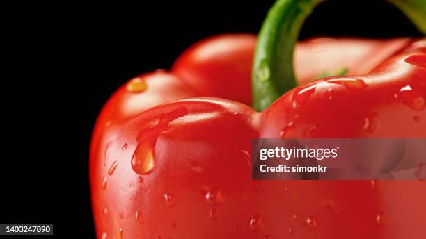 red bell pepper with water drops - red pepper stock pictures, royalty-free photos & images