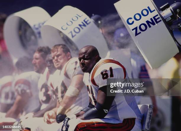 Melvin Tuten, Center and Offensive Tackle for the Cincinnati Bengals sits on the bench to keep cool from the heat by the large air conditioning...