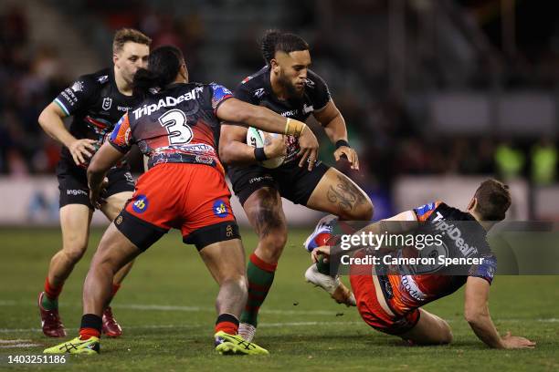 Keaon Koloamatangi of the Rabbitohs fends off Andrew McCullough of the Dragons during the round 15 NRL match between the St George Illawarra Dragons...