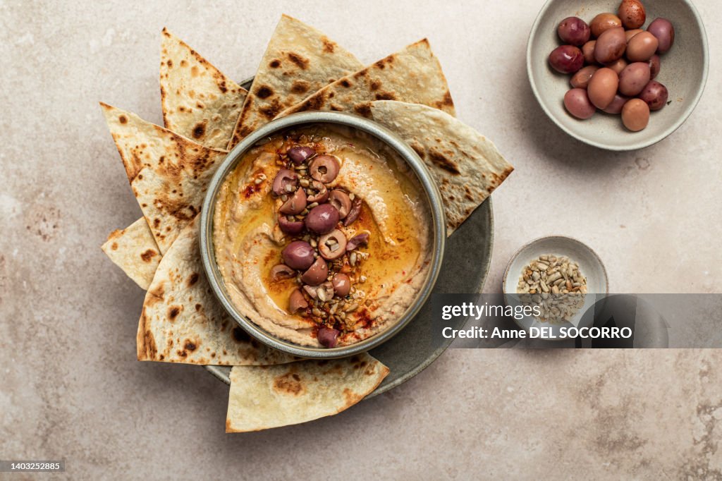 Olive and chickpea hummus with olive oil and pita bread