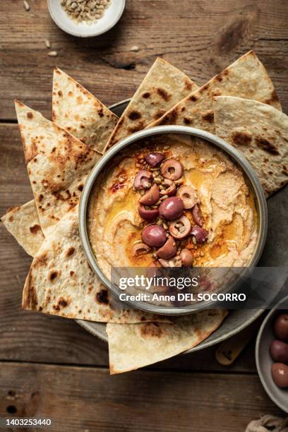 olive and chickpea hummus with olive oil and pita bread - tahini stock pictures, royalty-free photos & images