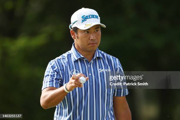 Hideki Matsuyama of Japan waves after putting on the 11th green during round one of the 122nd U.S. Open Championship at The Country Club on June 16,...