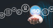 Businessman hand holding virtual ISO wording with Quality standard icon for company business certificated , ISO is International Standard Organization for Certified Quality Assurance concept.