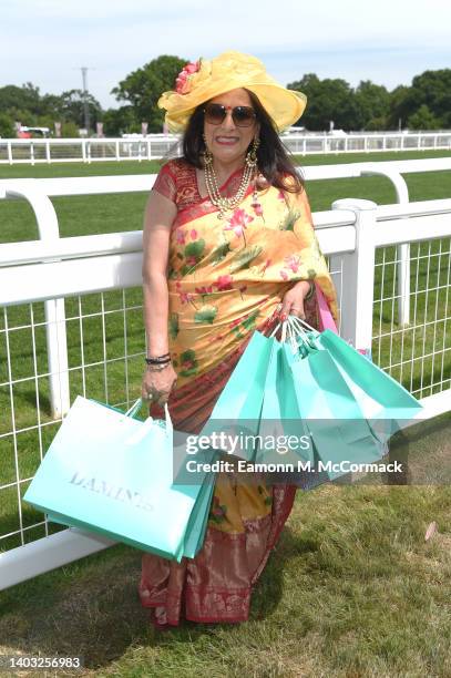 Racegoers wearing a saree poses for photographs during Royal Ascot 2022 at Ascot Racecourse on June 16, 2022 in Ascot, England.