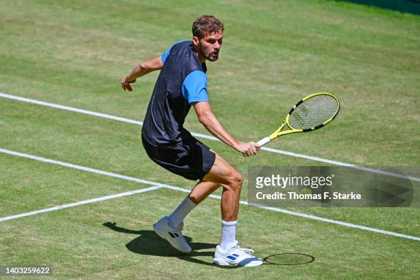 Oscar Otte of Germany plays a backhand in his match against Nikoloz Basilashvili of Georgia during day six of the 29th Terra Wortmann Open at...