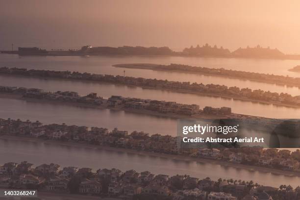 high angle view showing sunset over the palm jumeirah, dubai, united arab emirates - reclamation stock pictures, royalty-free photos & images