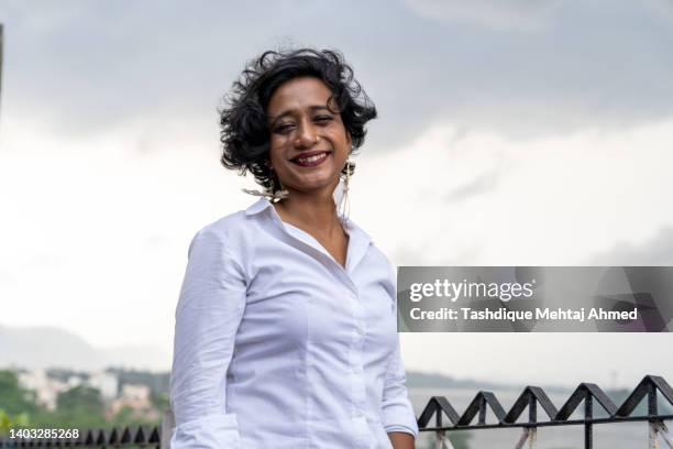young indian queer woman posing for the camera on a windy day. - indian lesbian stock pictures, royalty-free photos & images