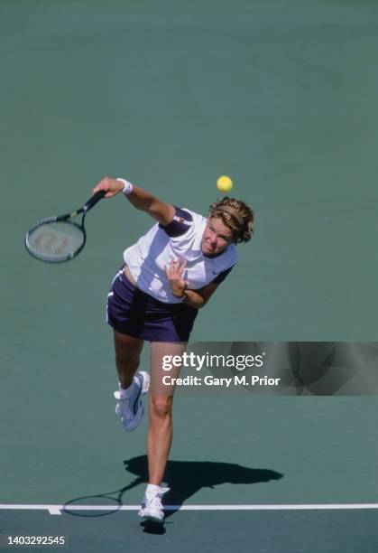 Lindsay Davenport of the United States reaches to serve to compatriot Serena Williams during their Evert Cup Women's Singles Second Round match on...