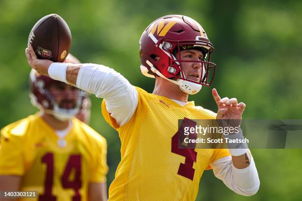 Taylor Heinicke of the Washington Commanders participates in a drill during the organized team activity at INOVA Sports Performance Center on June...