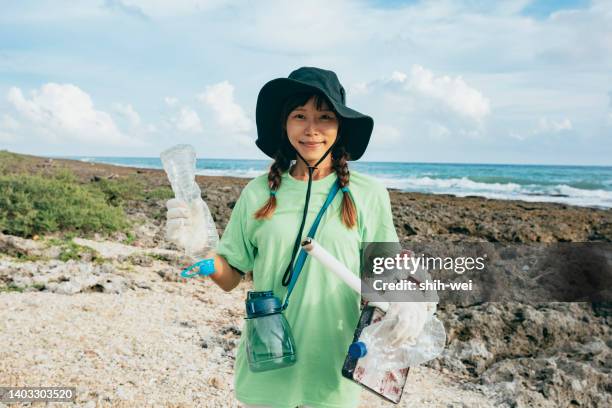 community volunteer groups on the beach - global charity initiative stock pictures, royalty-free photos & images