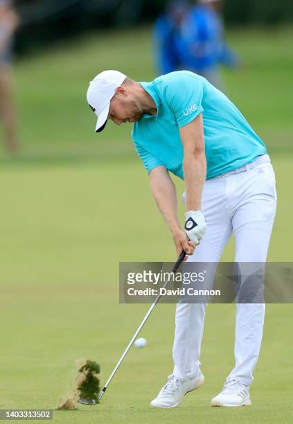 Daniel Berger of The United States plays his second shot on the 18th hole during the first round of the 2022 U.S.Open Championship at The Country...