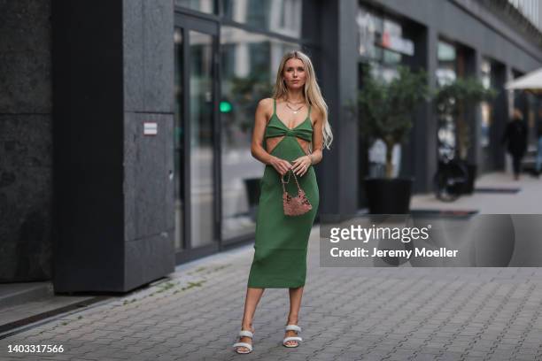 Scarlett Gartmann-Reus seen wearing a green ripped cut-out midi dress from Cult Gaia, white heels from Gia and a rose gold Paco Rabanne bag on June...