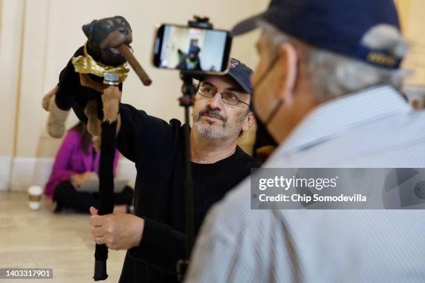 Actor and comedian Robert Smigel performs as Triumph the Insult Comic Dog in the hallways outside the House Select Committee to Investigate the...