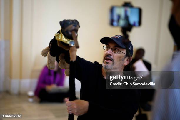 Actor and comedian Robert Smigel performs as Triumph the Insult Comic Dog in the hallways outside the House Select Committee to Investigate the...