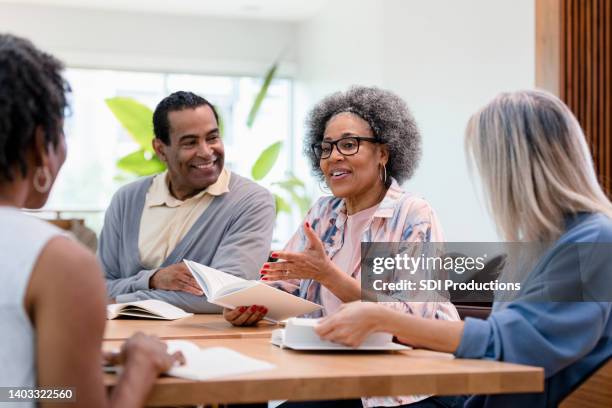 diverse group meets at the coffee shop - book club meeting stockfoto's en -beelden