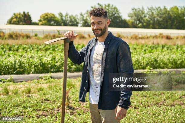 sunny portrait of bearded farmer and narrow garden hoe - garden hoe stock pictures, royalty-free photos & images