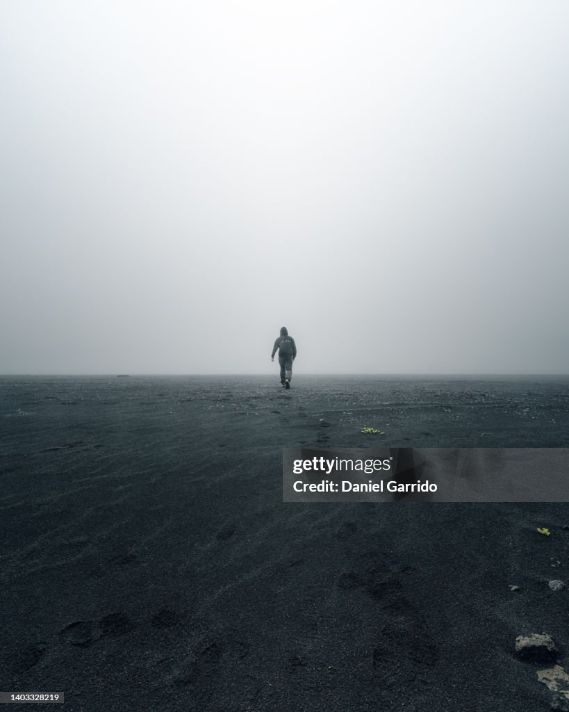 Walking alone into the fog, walking into nothingness, fog in Iceland, loneliness