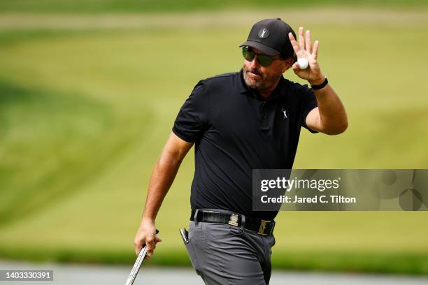 Phil Mickelson of the United States waves on the ninth green during round one of the 122nd U.S. Open Championship at The Country Club on June 16,...