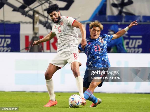 Ferjani Sassi of Tunisia and Ritsu Doan of Japan compete for the ball during the international friendly match between Japan and Tunisia at Panasonic...