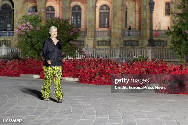 Dior designer Maria Grazia Chiuri waves after the presentation of the French brand Dior's Cruise 2023 collection at the Plaza de España, June 16 in...