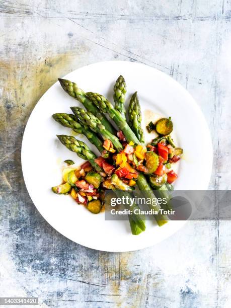 plate of asparagus salad on multicolored weathered background - asparagus stock pictures, royalty-free photos & images