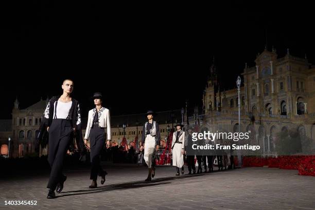 Few models walk the runway during the Dior "Crucero Collection" fashion show by Christian Dior at Plaza de España on June 16, 2022 in Seville, Spain.