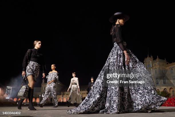 Few models walk the runway during the Dior "Crucero Collection" fashion show by Christian Dior at Plaza de España on June 16, 2022 in Seville, Spain.