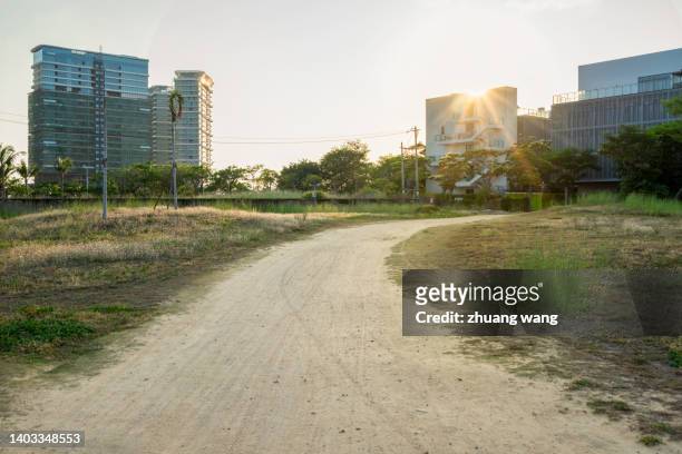 suburb with field grass - sanya stock pictures, royalty-free photos & images