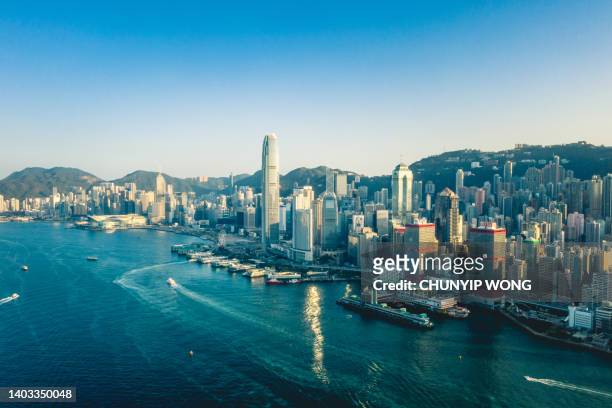 the hong kong city skyline at sunset - commercial buildings hong kong morning stock pictures, royalty-free photos & images
