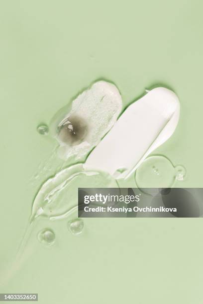 liquid cream cosmetic smudge texture gray beige background - hair products ストックフォトと画像