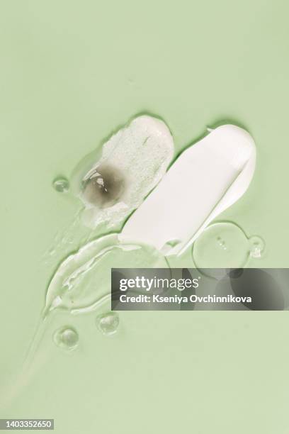 liquid cream cosmetic smudge texture gray beige background - oily skin stock pictures, royalty-free photos & images