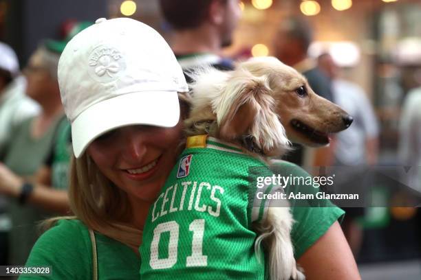 Boston Celtics fan holds her dog outside TD Garden prior to Game Six of the 2022 NBA Finals between the Golden State Warriors and the Boston Celtics...