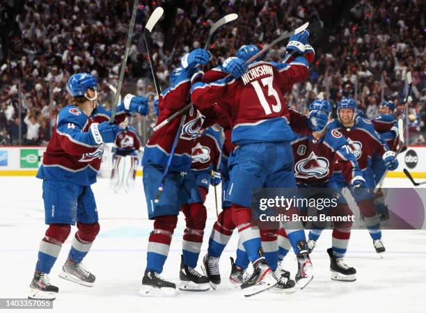 Andre Burakovsky of the Colorado Avalanche celebrates with teammates after scoring a goal against Andrei Vasilevskiy of the Tampa Bay Lightning...