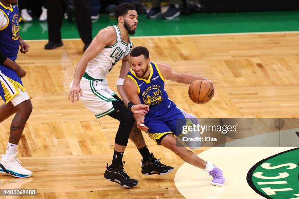 Stephen Curry of the Golden State Warriors dribbles against Jayson Tatum of the Boston Celtics during the second quarter in Game Six of the 2022 NBA...