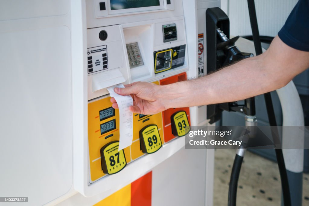 Man Purchases Gas at Pump Amid Skyrocketing Prices