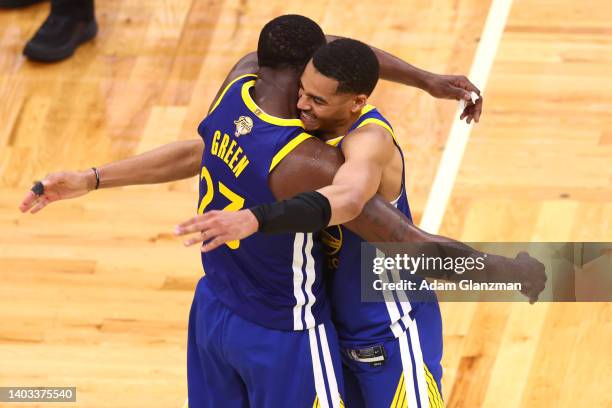 Jordan Poole and Draymond Green of the Golden State Warriors celebrate against the Boston Celtics during the fourth quarter in Game Six of the 2022...