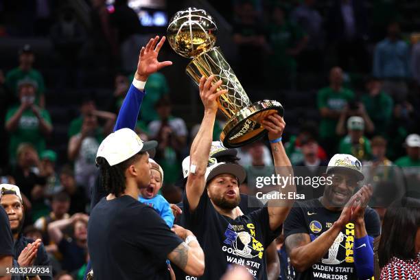 Stephen Curry of the Golden State Warriors raises the Larry O'Brien Championship Trophy after defeating the Boston Celtics 103-90 in Game Six of the...