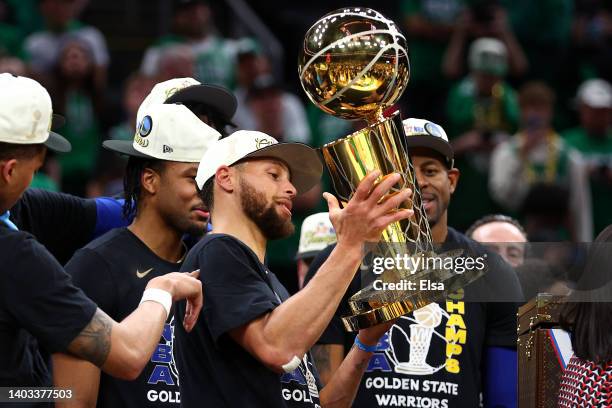 Stephen Curry of the Golden State Warriors raises the Larry O'Brien Championship Trophy after defeating the Boston Celtics 103-90 in Game Six of the...