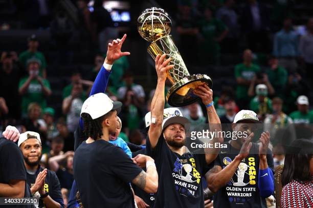 Stephen Curry of the Golden State Warriors raises the Larry O'Brien Championship Trophy after defeating the Boston Celtics 103-90 in Game Six of the...