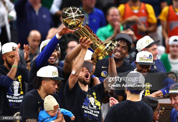 Stephen Curry of the Golden State Warriors raises the Larry O'Brien Championship Trophy after defeating the Boston Celtics 103-90 in Game Six of the...