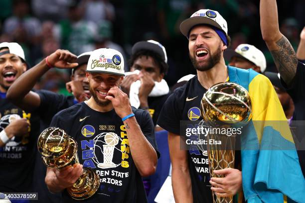 Stephen Curry and Klay Thompson of the Golden State Warriors celebrate with the Bill Russell NBA Finals Most Valuable Player Award and the Larry...