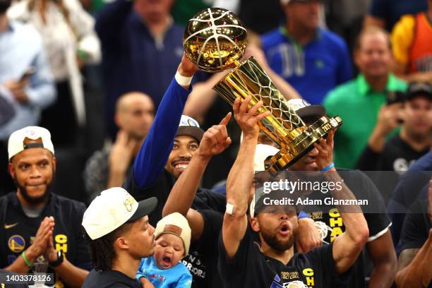 Stephen Curry of the Golden State Warriors raises the Larry O'Brien Championship Trophy after defeating the Boston Celtics 103-90 in Game Six of the...