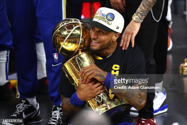 Gary Payton II of the Golden State Warriors celebrates with the Larry O'Brien Championship Trophy after defeating the Boston Celtics 103-90 in Game...
