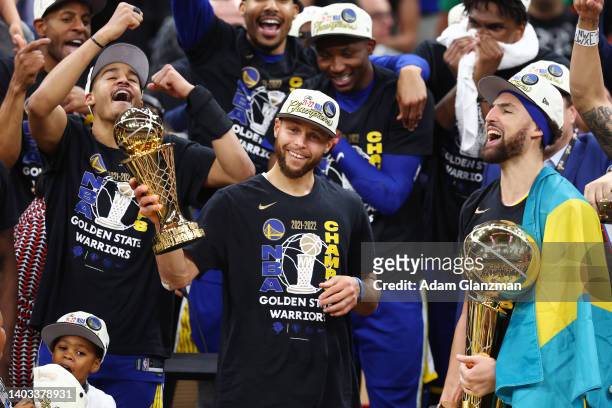 Stephen Curry and Klay Thompson of the Golden State Warriors celebrate with the Bill Russell NBA Finals Most Valuable Player Award and the Larry...