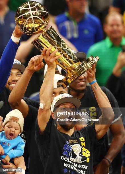 Stephen Curry of the Golden State Warriors raises the Larry O'Brien Championship Trophy after defeating the Boston Celtics 103-90 in Game Six of the...