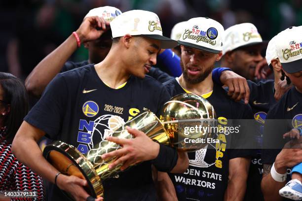 Jordan Poole of the Golden State Warriors celebrates with the Larry O'Brien Championship Trophy after defeating the Boston Celtics 103-90 in Game Six...