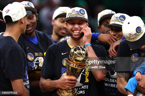 Stephen Curry of the Golden State Warriors celebrates with the Bill Russell NBA Finals Most Valuable Player Award after defeating the Boston Celtics...