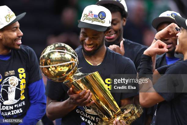 Andrew Wiggins of the Golden State Warriors celebrates with th Larry O'Brien Championship Trophy after defeating the Boston Celtics 103-90 in Game...