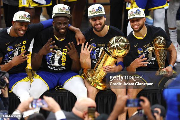 Andre Iguodala, Draymond Green, Klay Thompson and Stephen Curry of the Golden State Warriors pose for a photo after defeating the Boston Celtics...